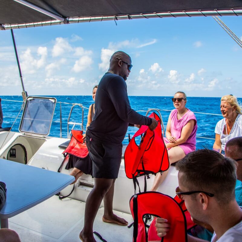 Handing out lifevests on boat