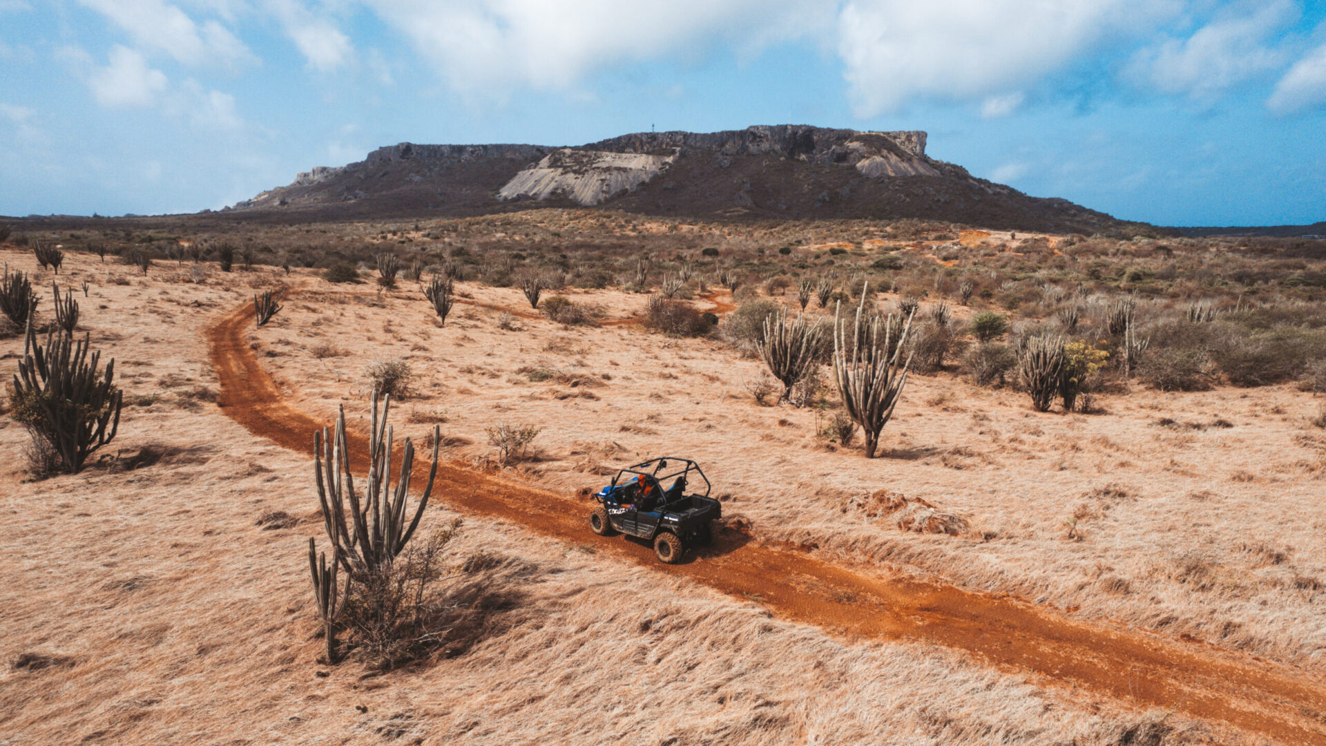 atv going through desert looking landscape