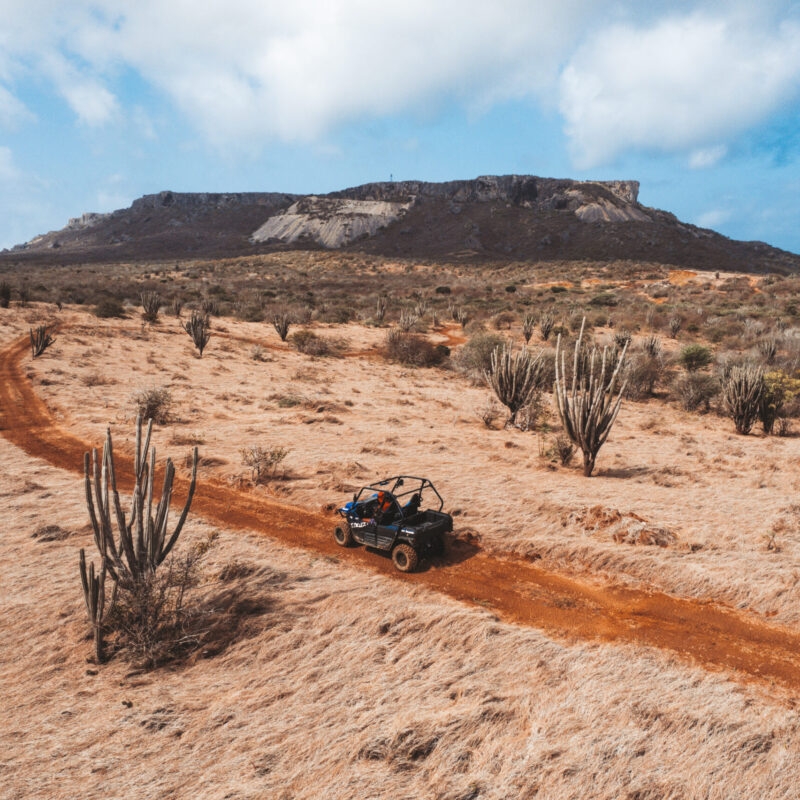 atv going through desert looking landscape