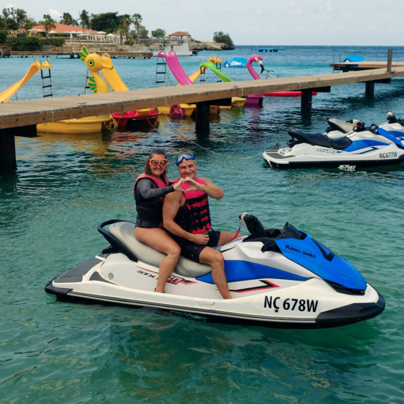 Couple on jet ski making a heart