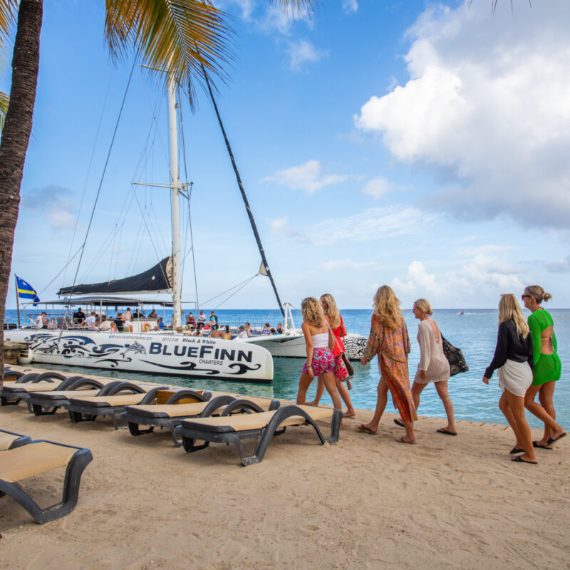 people boarding the boat from the beach