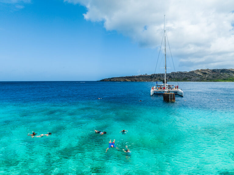 Catamaran with people swimming