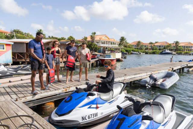 family getting instructions by the dock